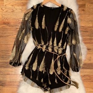 Black romper with gold embellished feathers